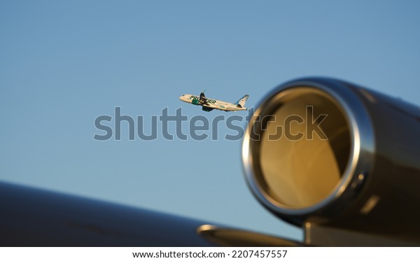 Frontier Airlines taking of and flying from San\
Francisco International Airport with another airplane in\
foreground. California,\
2022.