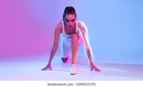 Front-View Of Motivated Lady Runner Doing Crouch Start Looking At Camera Ready For Race Posing On Pink And Blue Neon Studio Background. Fit Woman Preparing For Running Workout. Digital Sport, Collage - Powered by Shutterstock