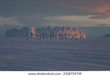 frosen sea and icebergs in evening light in Antarctica