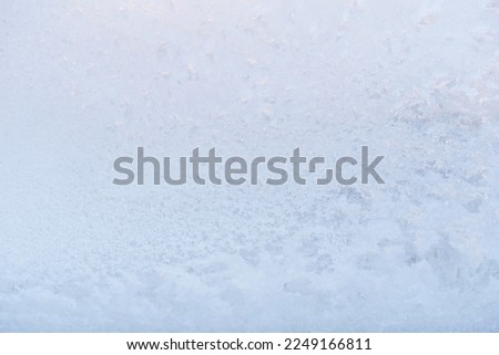 Frost ice patterns on a window glass. Rime on a windowpane, Bitter cold