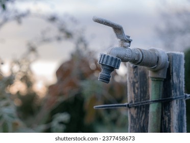Frost on the garden tap in the early morning. Garden water tap.