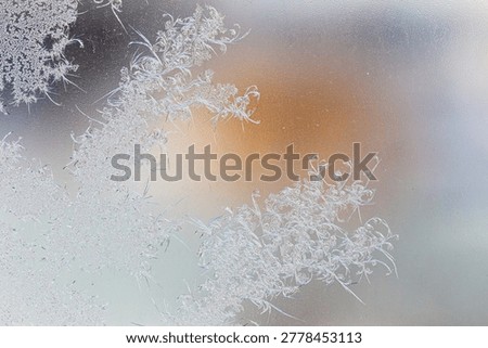 Frost pattern on window glass as background.