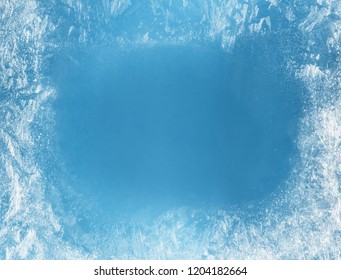 Frost patterns on frozen window as a symbol of Christmas wonder. Christmas or New year background.