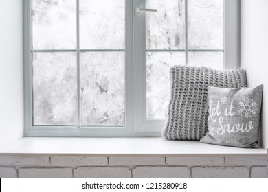 Сozy And Frost Winter Still Life:  Hot Tea Or Coffee  Warm Woolen Knitting Decoration On Windowsill Against Snow Landscape From Outside.