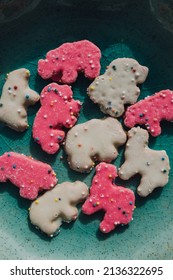 Frosted Circus Animal Cookie Pink And White Sprinkled Animal Crackers On Teal Plate