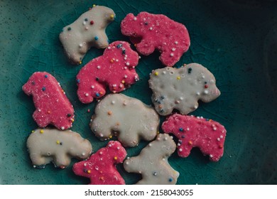 Frosted Circus Animal Cookie Pink And White Sprinkled Animal Crackers On Teal Plate