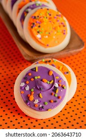 Frosted Icing Sugar Cookies On Black And Orange Polkadot Table