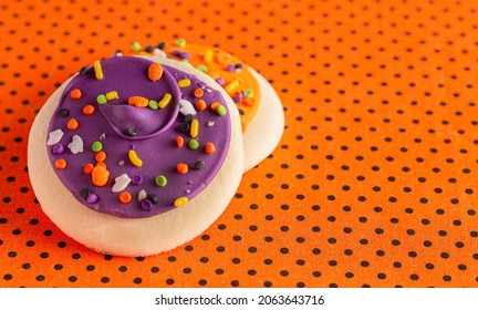 Frosted Icing Sugar Cookies On Black And Orange Polkadot Table