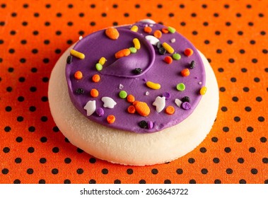 Frosted Icing Sugar Cookies On Black And Orange Polkadot Table