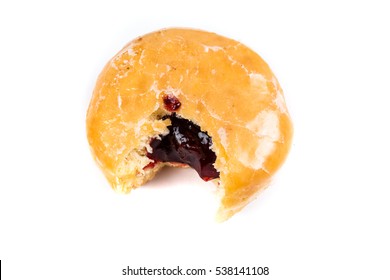 A frosted jelly filled donut with a bite out of it isolated on a white background