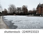 Frosted pond next to Brasserie Mariadal building in Zaventem, Belgium