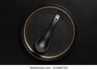 Frosted spoon on a ceramic dinner plate. The background is black leather. Luxurious, sumptuous fine tableware.Flat lay, top view, banner,vertical photo
 - Shutterstock ID 2218687103
