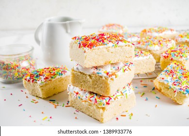 Frosted Sugar Cookie Bars, With Sugar Topping And Colorful Sugar Crumbles, White Marble Background Copy Space