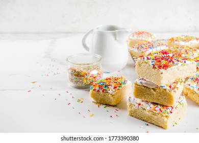 Frosted Sugar Cookie Bars, With Sugar Topping And Colorful Sugar Crumbles, White Marble Background Copy Space