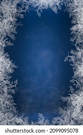 Frostwork. Frosty Frame. Decorative Ice Crystals Frame On Dark Blue Background