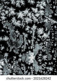 Frostwork Pattern Ice Crystals On Black Background. Dark Surface With Abstract Ice Structure Makes To Overlay Or Add A Frost Effect. Frost On The Glass, The Effect Of Freezing