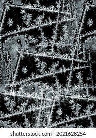Frostwork pattern ice crystals on black background. Dark surface with abstract ice structure makes to overlay or add a frost effect. Frost on the glass, the effect of freezing