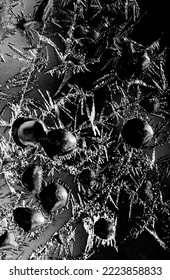 Frostwork pattern ice crystals on black background. Dark surface with abstract ice structure makes to overlay or add a frost effect. Frost on the glass, the effect of freezing