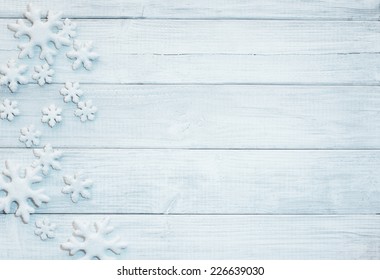Frosty 3D Snowflakes on Rustic Wood Board Background with empty room or space for copy, text, your words.  Horizontal blue tone white or gray