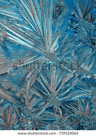 Frosty christmas pattern at a winter window glass