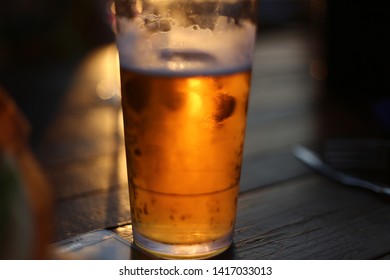 Frosty Icy Cold Beer In Glass With Sun Backlight