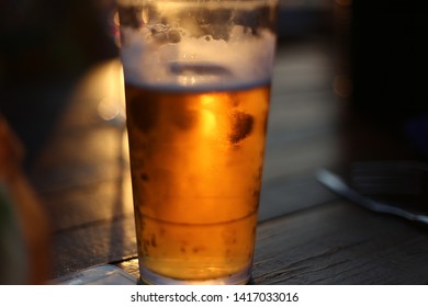 Frosty Icy Cold Beer In Glass With Sun Backlight