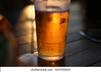 Frosty Icy Cold Beer In Glass With Sun Backlight