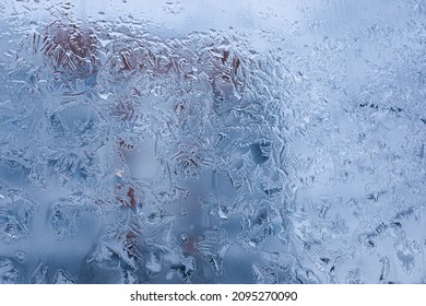 Frosty patterns, icy window. Winter urban background, close-up.