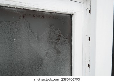 Frosty window of a black and white painted outdoor sauna in Finland, Northern Europe during an early winter day. Closeup image, no people. Snowy winter day. - Powered by Shutterstock