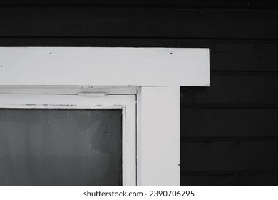 Frosty window of a black and white painted outdoor sauna in Finland, Northern Europe during an early winter day. Closeup image, no people. Snowy winter day. - Powered by Shutterstock