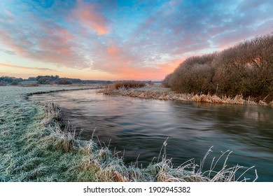 A frosty winter sunrise over the river Frome at Holmebridge between Wool and Wareham in the Dorset countryside.