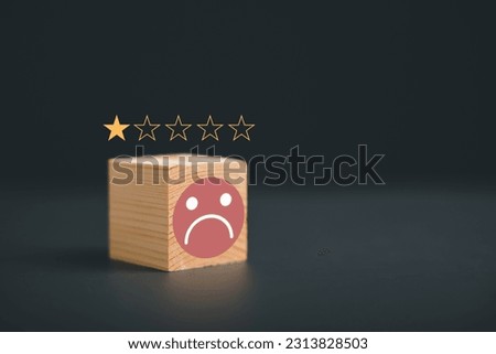 Frown icon on cube wooden block on black background. Customer satisfaction evaluation concept, bad experience, bad review, not satisfied, low score, bad service dislike bad quality ストックフォト © 