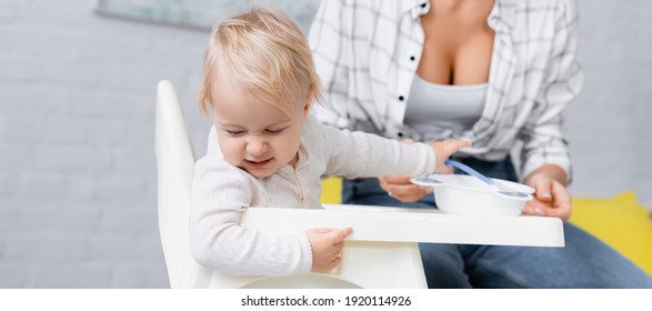 Frowning Child Turning Away From Food Near Mother On Blurred Background, Banner