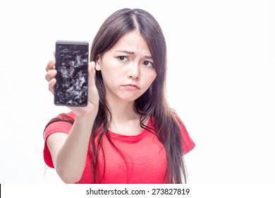 Frowning Chinese Woman Holding Cell Phone With Cracked Screen