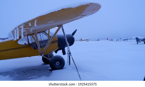 Frozen Alaska Bush Plane On Snowy Foggy Ramp