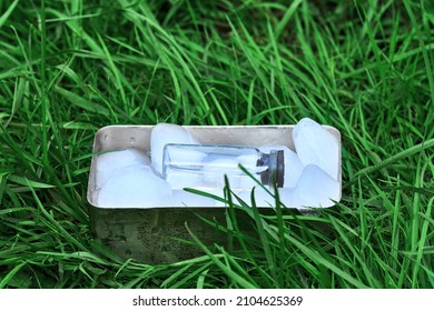 Frozen Ampoule With Medicine On A Background Of Herbs.