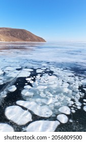 Frozen Baikal Lake. Beautiful Bright Landscape With White Bubbles Of Bottom Natural Gases In The Thickness Of Blue Transparent Ice On A Sunny February Day. Winter Travel And Hike (focus On Ice)