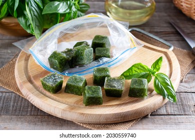 Frozen basil leaves (basilius) in ice cubes with fresh basil on a table. Frozen food concept - Powered by Shutterstock