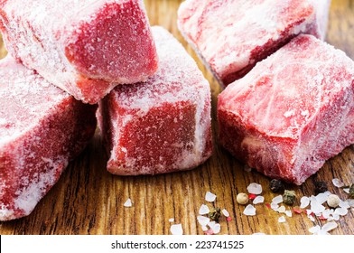 Frozen beef slices in hoarfrost close up