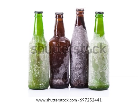 Frozen beer bottles on white isolated background