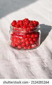 Frozen Berries In Glass Jar. Close Up Of Frozen Red Currant.