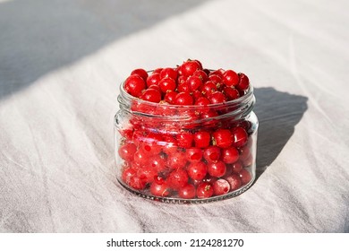 Frozen Berries In Glass Jar. Close Up Of Frozen Red Currant.