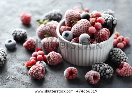 Frozen berries on a black wooden table
