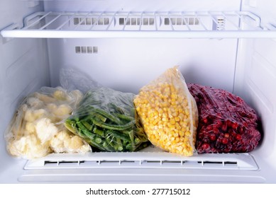 Frozen Berries And Vegetables In Bags In Freezer Close Up