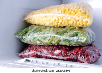 Frozen Berries And Vegetables In Bags In Freezer Close Up