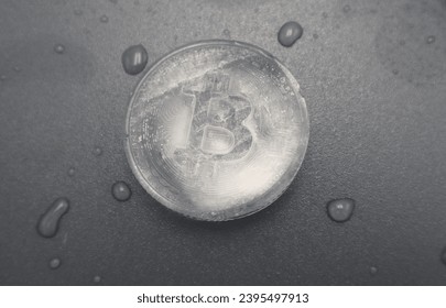 Frozen Bitcoin crypto currency ice cube block icon on black board in the freezer background - Shutterstock ID 2395497913