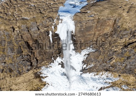 Frozen Bjarnarfoss Waterfall from an Elevated Drone Perspective