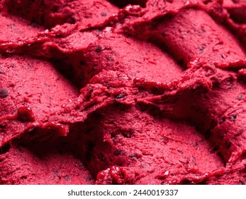 Frozen Black Currant flavour gelato - full frame detail of sorbet. Close up of a red surface texture of Ice cream filled with pieces of mixed fruit. - Powered by Shutterstock