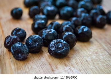 Frozen Blueberries On A Wooden Background. Macro Shot.