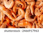 Frozen, boiled shrimp. Texture King prawns background. Seafood on the counter. Fish market. Close-up shot of seafood. Photo of shrimp in a supermarket. Wholesale of seafood. High quality photo